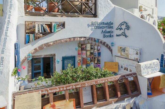 Cozy and grandiose library exterior with books and plants, showcasing a magical bookstore ambiance from around the world.